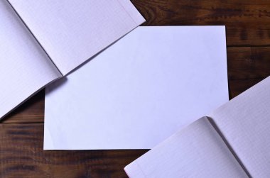 Bir temiz beyaz okul çek defteri kahverengi ahşap arka plan üzerinde fotoğraf. Fikir veya ileti kavramı. Metin için yeterince boş alana