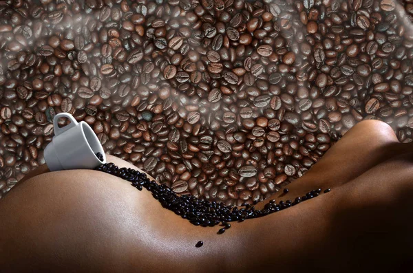 A photograph of a white cup of hot coffee with lots of coffee beans, which lies on a beautiful and sexy naked female body with a many beans in background pattern. Erotic photo about the coffee drinks