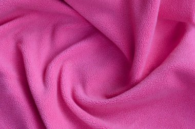 Tüylü pembe Polar kumaş battaniye. Hafif pembe yumuşak peluş Polar malzeme bir sürü kabartma kıvrımları ile bir arka plan