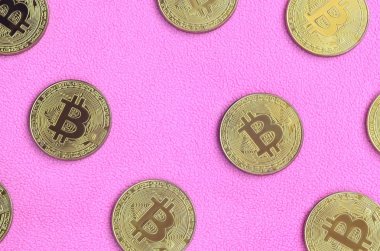 Birçok altın bitcoins yumuşak ve kabarık hafif pembe Polar kumaştan yapılmış bir battaniye yatıyor. Sanal Kripto para biriminin fiziksel görselleştirme