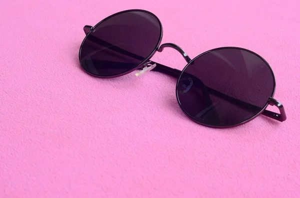 スタイリッシュな黒いサングラスのラウンド眼鏡あるふわふわの光ピンクのフリース生地で作られた毛布の上 女性色のファッショナブルな背景の画像 — ストック写真