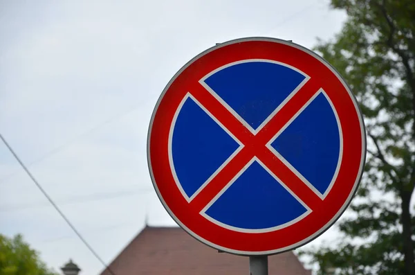 Round road sign with a red cross on a blue background. A sign means a parking prohibition — Stock Image Road Sign Red Cross Blue Background Sign Means Parking Prohibition Royalty Free Stock Photos