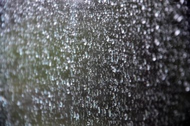 Arka plan resmi yağmur cam pencere üzerinde bırakır. Makro fotoğraf ile sığ derinlik-in tarla