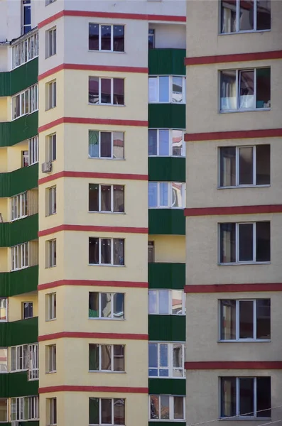 New or recently completed multi-storey residential building with windows and balconies. Russian type of house building