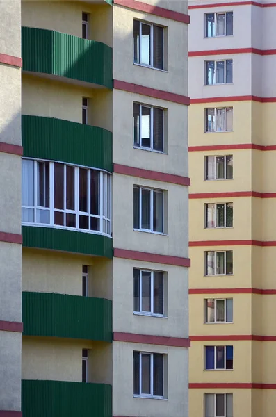 New or recently completed multi-storey residential building with windows and balconies. Russian type of house building