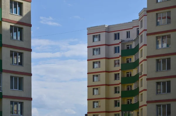 New or recently completed multi-storey residential building with windows and balconies. Russian type of house building