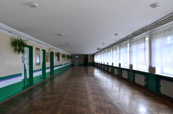 The gloomy corridor of a neglected public building. Public space in a poor residential high-rise building