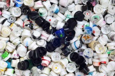 Çok sayıda grafiti sprey boya bidon kapakları. Renkli boya püskürtme uçlarını yalan büyük bir yığın ile bulaşmış