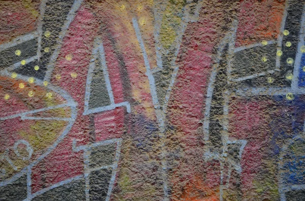 Texture of a fragment of the wall with graffiti painting, which is depicted on it. An image of a piece of graffiti drawing as a photo on street art and graffiti culture topics