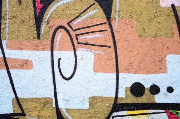 Texture of a fragment of the wall with graffiti painting, which is depicted on it. An image of a piece of graffiti drawing as a photo on street art and graffiti culture topics