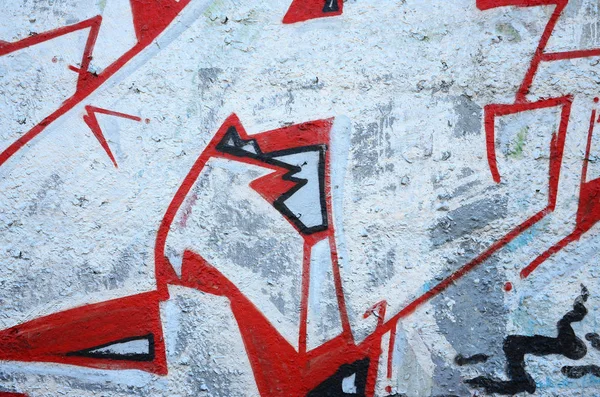 Texture of a fragment of the wall with graffiti painting, which is depicted on it. An image of a piece of graffiti drawing as a photo on street art and graffiti culture topics