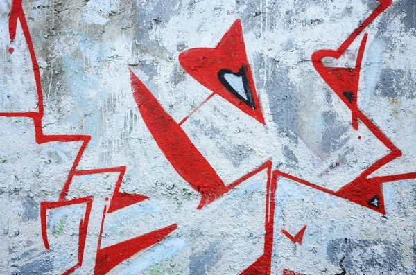 Texture of a fragment of the wall with graffiti painting, which is depicted on it. An image of a piece of graffiti drawing as a photo on street art and graffiti culture topics