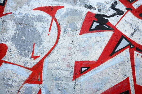 Texture of a fragment of the wall with graffiti painting, which is depicted on it. An image of a piece of graffiti drawing as a photo on street art and graffiti culture topics