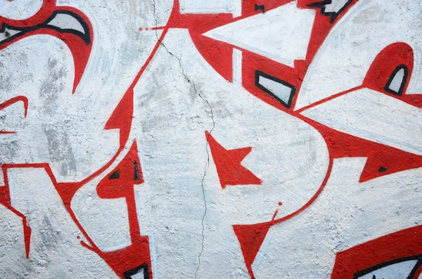 Texture of a fragment of the wall with graffiti painting, which is depicted on it. An image of a piece of graffiti drawing as a photo on street art and graffiti culture topics