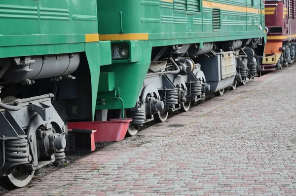 The wheels of a modern Russian electric train with shock absorbers and braking devices. The side of the cab