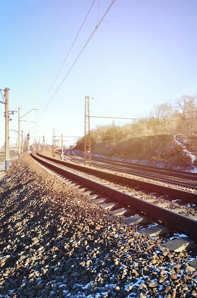 Landscape of a snowy Russian winter railway under bright sunlight The rails and sleepers under the December snow. Russian Railways in detail