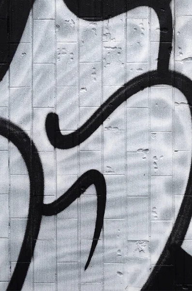 A fragment of a graffiti pattern, applied to a wall of cold tiles, which is covered with a fine condensate. The concept of street art in inappropriate weather