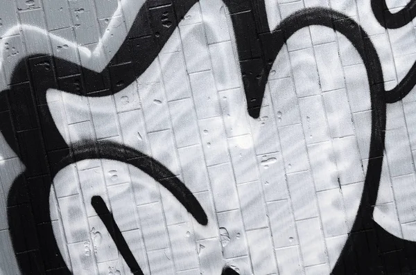 A fragment of a graffiti pattern, applied to a wall of cold tiles, which is covered with a fine condensate. The concept of street art in inappropriate weather