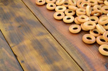 Bir sürü taze sarı simit eski koyu renkli ahşap yüzeyde yalan. Unlu Mamüller popüler bir tür. Bir geleneksel Rus Çay için davranır