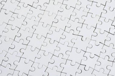 Beyaz jigsaw bulmaca monte durumda doku kapatın. Üstten Görünüm. Büyük bir bütün mozaik birçok bileşenleri birleştirilmiştir