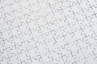 Beyaz jigsaw bulmaca monte durumda doku kapatın. Üstten Görünüm. Büyük bir bütün mozaik birçok bileşenleri birleştirilmiştir