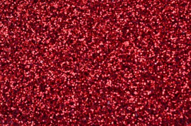 Kırmızı dekoratif payetler büyük miktarda. Arka plan bulanık görüntü parlak bokeh ışıklar ışık rasgele bir sırada yansıtan küçük elemanları ile