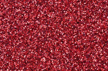 Kırmızı dekoratif payetler büyük miktarda. Arka plan doku ışık rasgele bir sırada yansıtmak, küçük parlak elemanları ile. Glitter doku