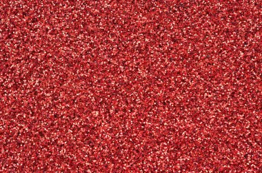 Kırmızı dekoratif payetler büyük miktarda. Arka plan doku ışık rasgele bir sırada yansıtmak, küçük parlak elemanları ile. Glitter doku