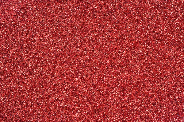 Kırmızı dekoratif payetler büyük miktarda. Arka plan doku ışık rasgele bir sırada yansıtmak, küçük parlak elemanları ile. Glitter doku