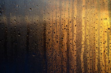 Buğulu cam damlar şafakta güneş ışığına karşı yoğunlaşma ve bir çok damla doku. Arka plan resmi