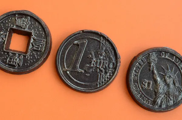 Three chocolate products in the form of Euro, USA and Japan coin