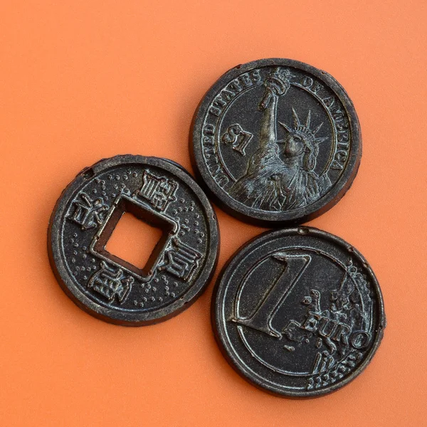 Three Chocolate Products Form Euro Usa Japan Coins Lie Orange — Stock Photo, Image