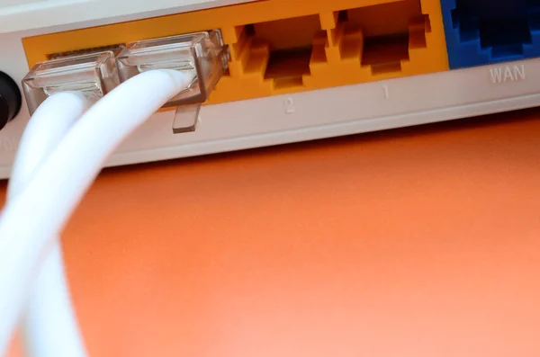 The Internet cable plugs are connected to the Internet router, which lies on a bright orange background. Items required for Internet connection