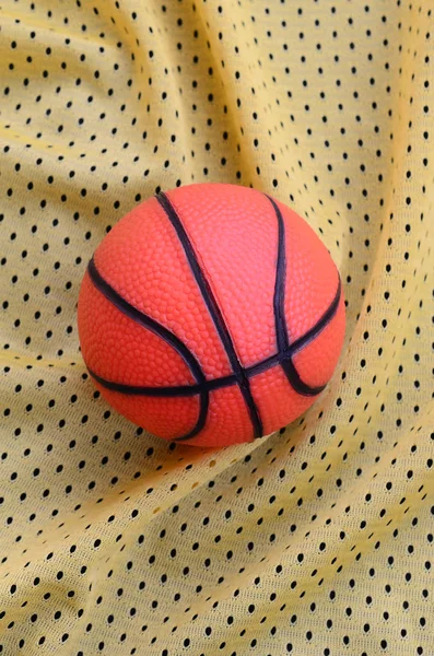 Malé Oranžové Gumové Basketbal Leží Žluté Sportovní Dres Oděvní Textilie — Stock fotografie