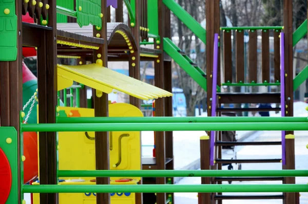 Fragment of a playground made of plastic and wood, painted in different colors