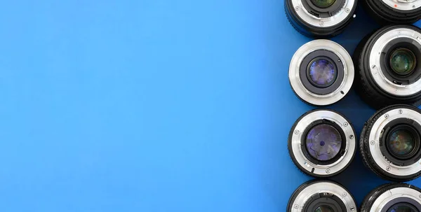Several Photographic Lenses Lie Bright Blue Background Space Text — Stock Photo, Image