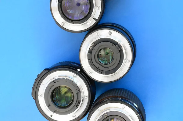 Several Photographic Lenses Lie Bright Blue Background Space Text — Stock Photo, Image