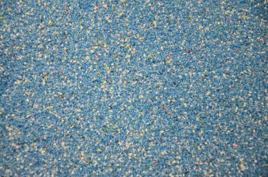 Texture of a colored granular sand close up. Blue grains clipart