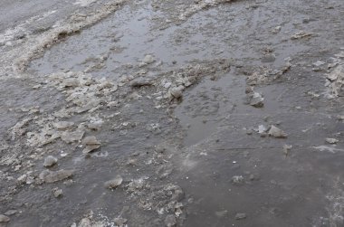 Asfalt yol ile çukurların dondurma ve çözme döngüsü sırasında belgili tanımlık kış nedeniyle zarar görmüş. Zavallı yol