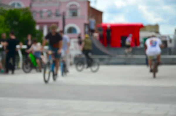 Defocused image of a lot of people with bmx bikes. Meeting of fans of extreme sports