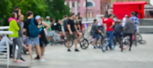 Defocused image of a lot of people with bmx bikes. Meeting of fans of extreme sports