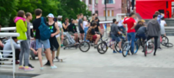 Defocused image of a lot of people with bmx bikes. Meeting of fans of extreme sports