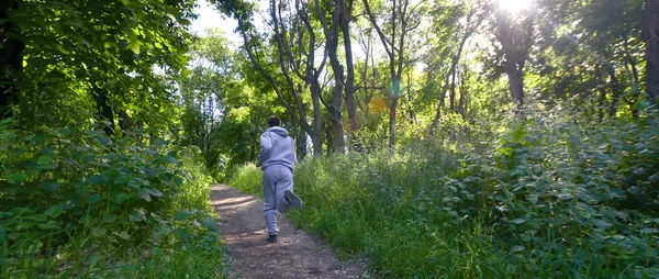 Young Guy Gray Sports Suit Runs Path Trees Forest Sports — Stock Photo, Image