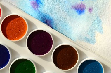 Bir mavi vuruş şeklinde soyut bir suluboya çizim gösteren kağıt üzerine suluboya yeni bir dizi yatıyor. Gençler arasında amatör resim kavramı