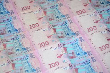 Bir close-up desenle 200 hryvnia par değeri birçok Ukrayna para birimi banknotlar. Arka plan resmi iş Ukrayna