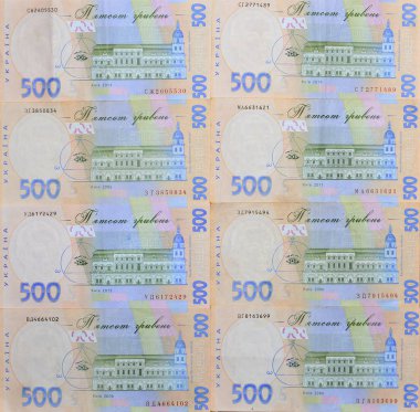 A close-up of a pattern of many Ukrainian currency banknotes with a par value of 500 hryvnia. Background image on business in Ukraine clipart