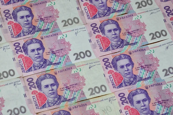 Bir close-up desenle 200 hryvnia par değeri birçok Ukrayna para birimi banknotlar. Arka plan resmi iş Ukrayna
