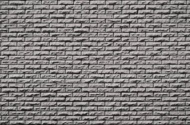 Parlak güneş ışığı altında kabartma taş tuğla duvar dokusu