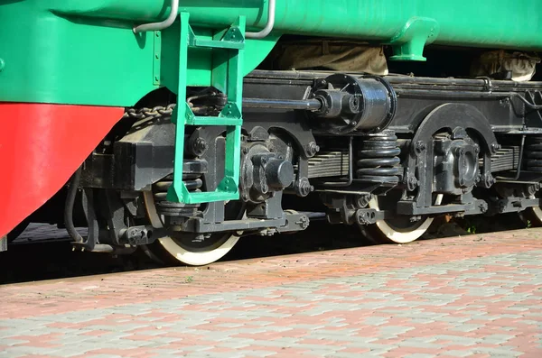 The wheels of a modern Russian electric train with shock absorbers and braking devices. The side of the cab