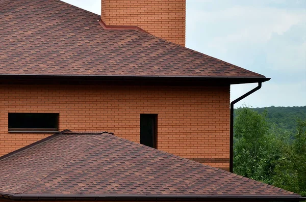 The house is equipped with high-quality roofing of shingles (bitumen tiles). A good example of perfect roofing. The roof is reliably protected from adverse weather conditions